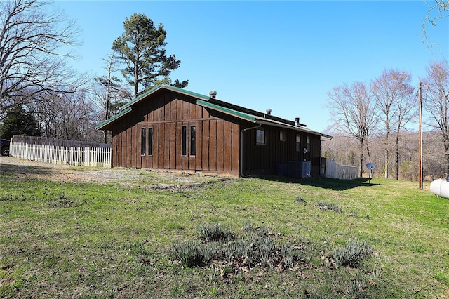 view of side of home with central AC and board and batten siding