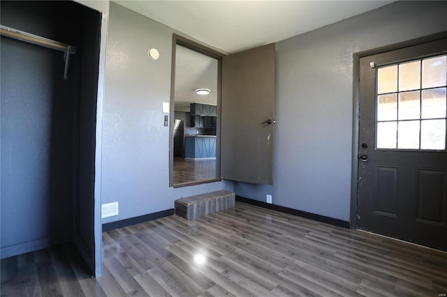 entryway with wood finished floors and baseboards