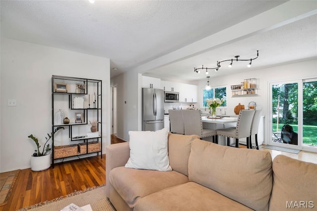 1680 Layven Ave, Florissant, MO 63031 - living area with dark wood-type flooring and a textured ceiling