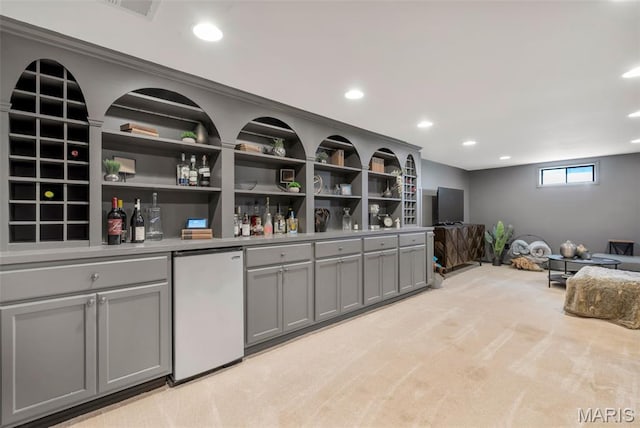 1680 Layven Ave, Florissant, MO 63031 - indoor dry bar featuring fridge, light colored carpet, and recessed lighting