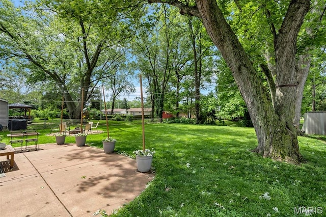 1680 Layven Ave, Florissant, MO 63031 - view of green lawn featuring a gazebo and a patio