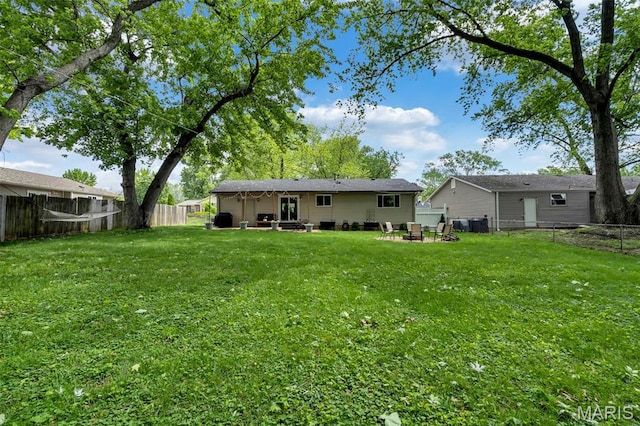 1680 Layven Ave, Florissant, MO 63031 - back of house with a fenced backyard, an outdoor fire pit, and a patio area