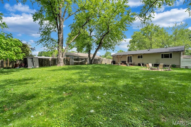 1680 Layven Ave, Florissant, MO 63031 - fenced backyard featuring a patio area and a shed