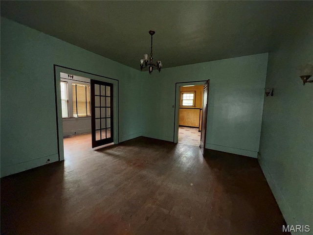 1548 Highland Ave, Alton, IL 62002 - spare room with a chandelier, baseboards, and dark wood finished floors