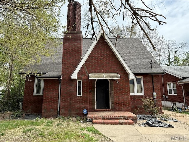 1548 Highland Ave, Alton, IL 62002 - view of front of home with roof with shingles, brick siding, and a chimney