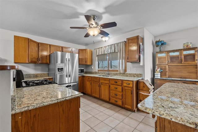 7238 State Highway D, Jackson, MO 63755 - kitchen with stainless steel appliances, a sink, brown cabinetry, and ceiling fan