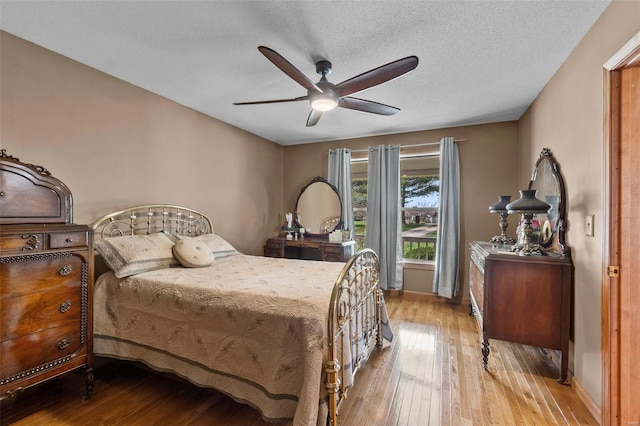 7238 State Highway D, Jackson, MO 63755 - bedroom featuring wood-type flooring, baseboards, a textured ceiling, and a ceiling fan