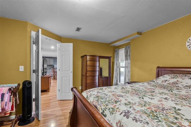 7238 State Highway D, Jackson, MO 63755 - bedroom with light wood-style flooring and a textured ceiling
