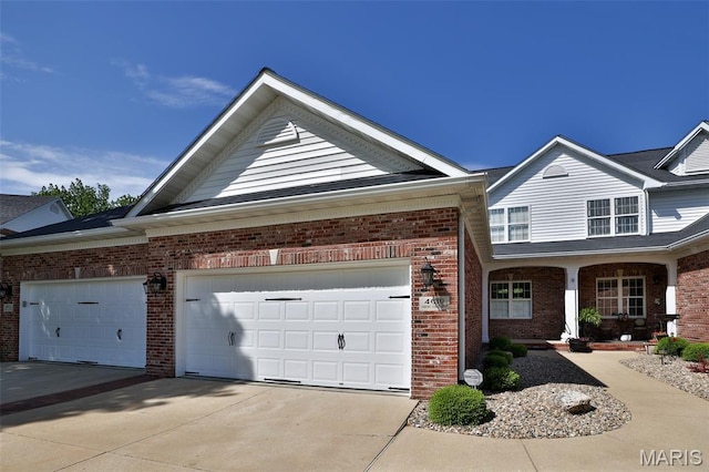 409 Country Club Vw, Edwardsville, IL 62025 - view of front facade featuring brick siding, driveway, and a garage