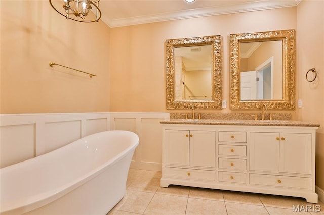 409 Country Club Vw, Edwardsville, IL 62025 - bathroom with ornamental molding, a freestanding bath, double vanity, tile patterned floors, and wainscoting