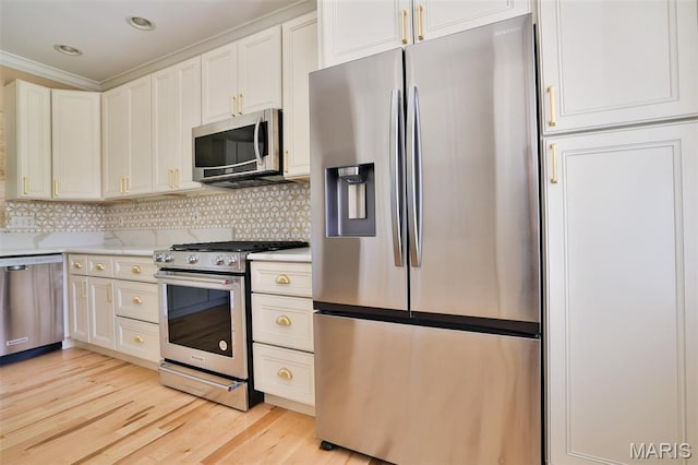 409 Country Club Vw, Edwardsville, IL 62025 - kitchen featuring appliances with stainless steel finishes, light countertops, light wood-style floors, ornamental molding, and white cabinets