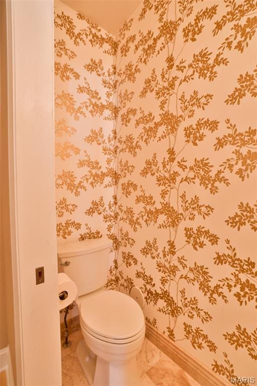 409 Country Club Vw, Edwardsville, IL 62025 - bathroom featuring toilet, marble look tile flooring, baseboards, and wallpapered walls