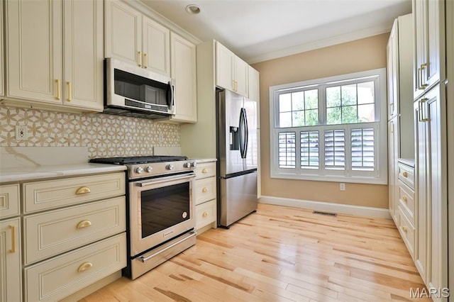 409 Country Club Vw, Edwardsville, IL 62025 - kitchen with stainless steel appliances, baseboards, backsplash, light wood-type flooring, and ornamental molding