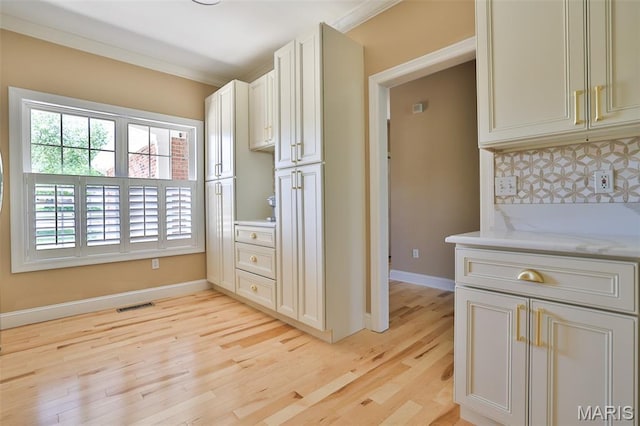 409 Country Club Vw, Edwardsville, IL 62025 - kitchen featuring light wood finished floors, baseboards, tasteful backsplash, and light stone counters