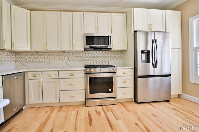 409 Country Club Vw, Edwardsville, IL 62025 - kitchen with appliances with stainless steel finishes, light wood-style floors, backsplash, ornamental molding, and light stone counters