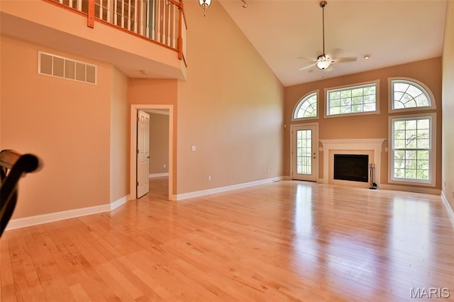 409 Country Club Vw, Edwardsville, IL 62025 - unfurnished living room with high vaulted ceiling, ceiling fan, light wood-type flooring, baseboards, and a fireplace