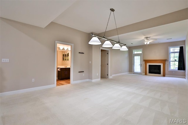 409 Country Club Vw, Edwardsville, IL 62025 - unfurnished living room with light colored carpet, baseboards, a ceiling fan, and a fireplace