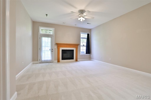 409 Country Club Vw, Edwardsville, IL 62025 - unfurnished living room featuring a glass covered fireplace, ceiling fan, light carpet, and baseboards