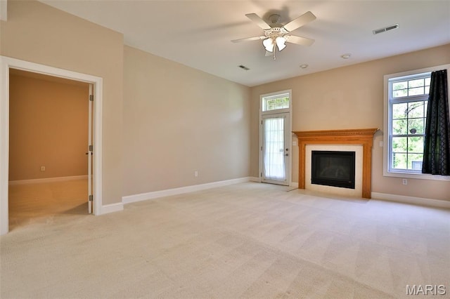 409 Country Club Vw, Edwardsville, IL 62025 - unfurnished living room with a fireplace with flush hearth, baseboards, light colored carpet, and ceiling fan