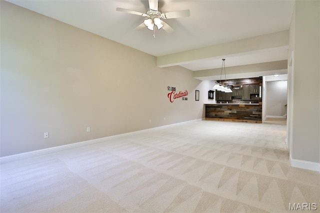 409 Country Club Vw, Edwardsville, IL 62025 - unfurnished living room with light carpet, baseboards, beam ceiling, and ceiling fan