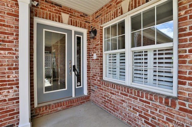 409 Country Club Vw, Edwardsville, IL 62025 - property entrance with brick siding, a security system, and covered porch
