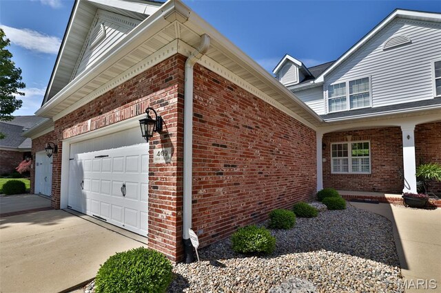 409 Country Club Vw, Edwardsville, IL 62025 - view of property exterior with an attached garage and brick siding
