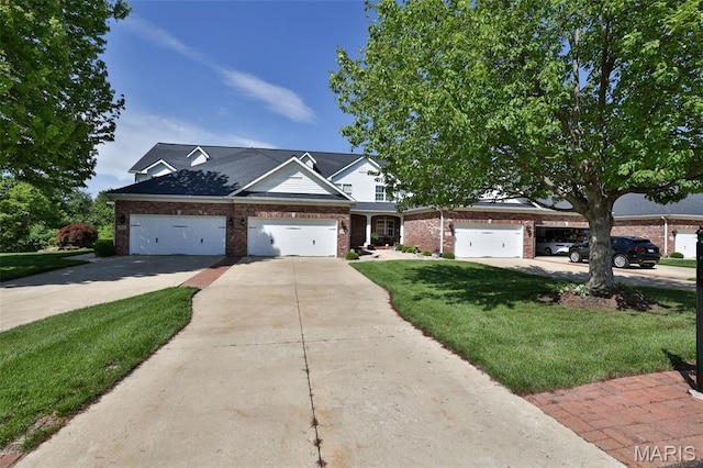 409 Country Club Vw, Edwardsville, IL 62025 - view of front of home with brick siding, concrete driveway, a front lawn, and a garage