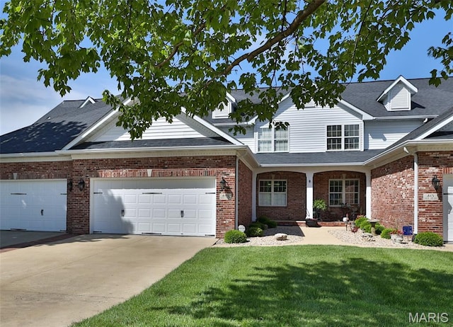 409 Country Club Vw, Edwardsville, IL 62025 - traditional-style house featuring a front lawn, concrete driveway, an attached garage, and brick siding