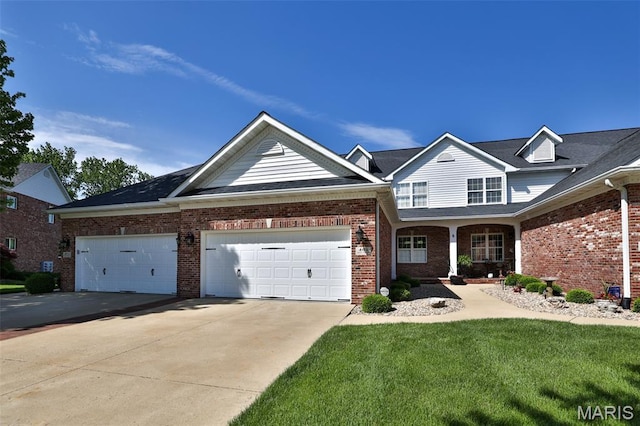 409 Country Club Vw, Edwardsville, IL 62025 - view of front facade with driveway, brick siding, a garage, and a front lawn