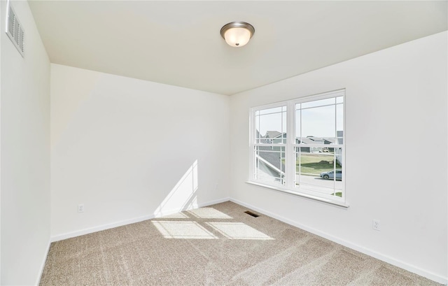 unfurnished room with carpet and baseboards