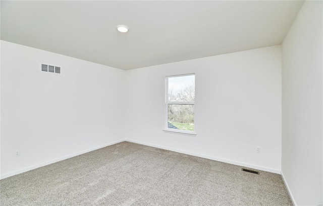 empty room featuring carpet floors and baseboards