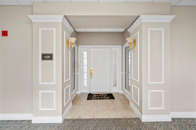 foyer entrance with tile patterned floors and baseboards