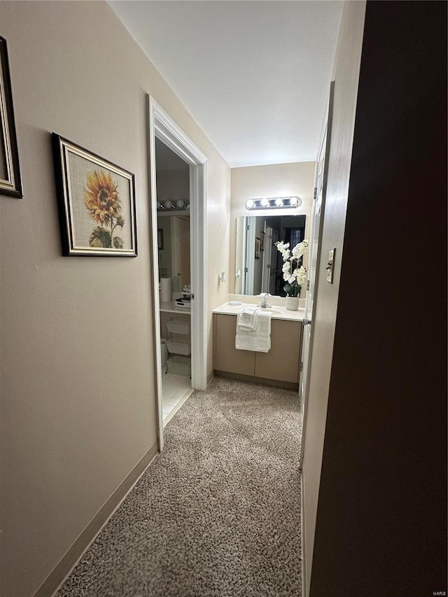 5316 Pershing Ave Unit 507, Saint Louis, MO 63112 - hall with a sink, baseboards, and light carpet
