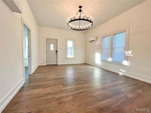 360 3rd St, Ellington, MO 63638 - entrance foyer with a wall mounted air conditioner, a chandelier, and dark wood-type flooring