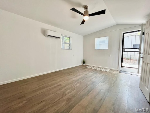 360 3rd St, Ellington, MO 63638 - spare room featuring a wall mounted air conditioner, wood finished floors, a ceiling fan, vaulted ceiling, and baseboards