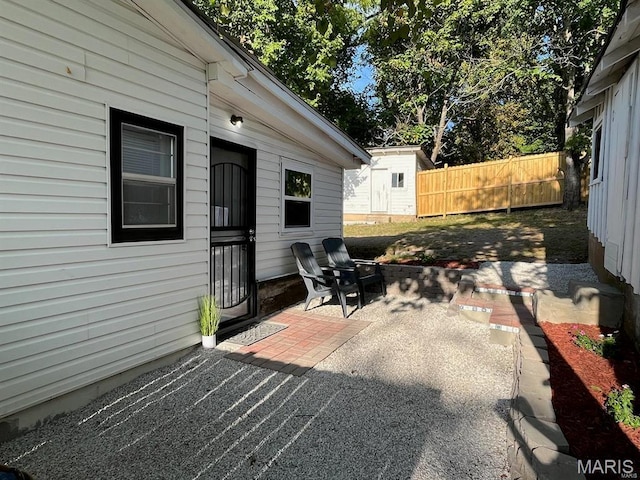 360 3rd St, Ellington, MO 63638 - view of patio / terrace with fence, an outbuilding, and a shed