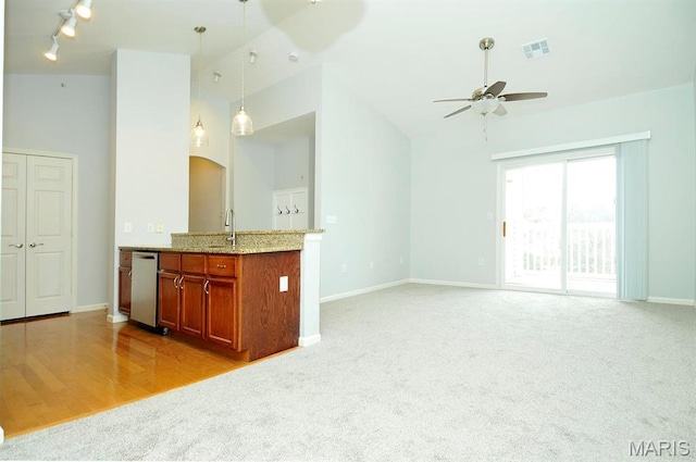 39 Kassebaum Ln Unit 303, Saint Louis, MO 63129 - unfurnished living room with a ceiling fan, a sink, baseboards, high vaulted ceiling, and light carpet