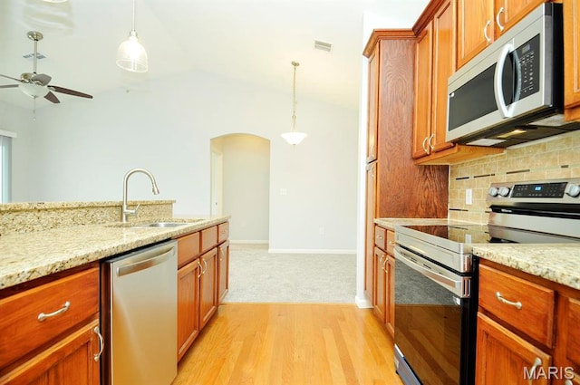 39 Kassebaum Ln Unit 303, Saint Louis, MO 63129 - kitchen featuring stainless steel appliances, a sink, tasteful backsplash, arched walkways, and pendant lighting