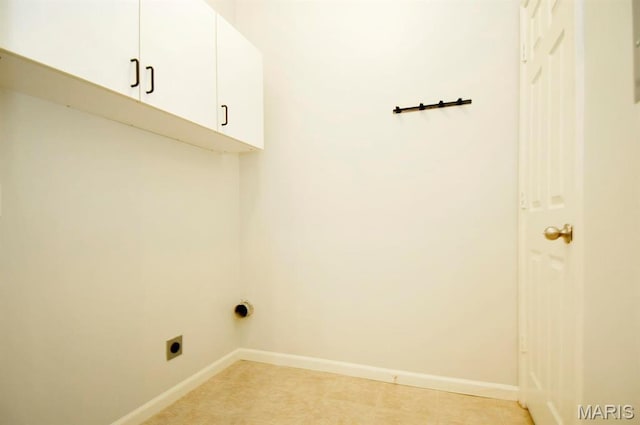 39 Kassebaum Ln Unit 303, Saint Louis, MO 63129 - laundry room featuring electric dryer hookup, cabinet space, baseboards, and light tile patterned floors