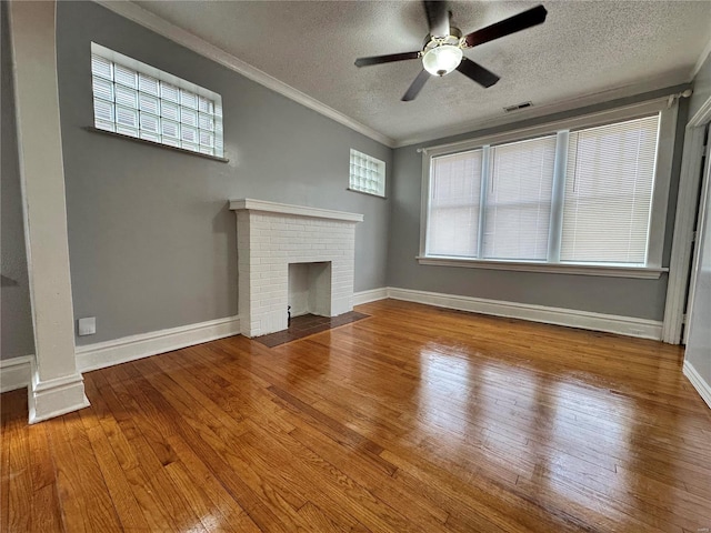 5056 Lindenwood Ave, Saint Louis, MO 63109 - unfurnished living room featuring a textured ceiling, hardwood / wood-style floors, a ceiling fan, healthy amount of natural light, and ornamental molding