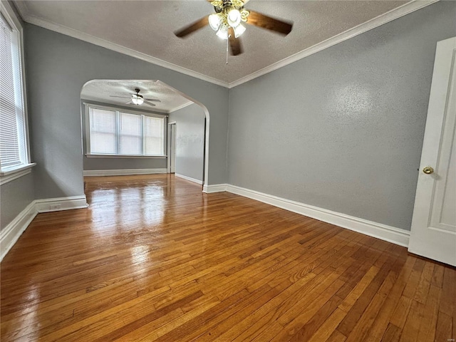 5056 Lindenwood Ave, Saint Louis, MO 63109 - unfurnished room featuring arched walkways, a ceiling fan, hardwood / wood-style floors, a textured ceiling, and baseboards