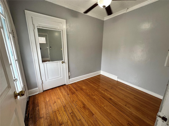 5056 Lindenwood Ave, Saint Louis, MO 63109 - spare room featuring a ceiling fan, wood finished floors, baseboards, and crown molding