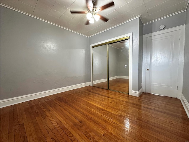 5056 Lindenwood Ave, Saint Louis, MO 63109 - unfurnished bedroom featuring crown molding, wood finished floors, a closet, baseboards, and ceiling fan