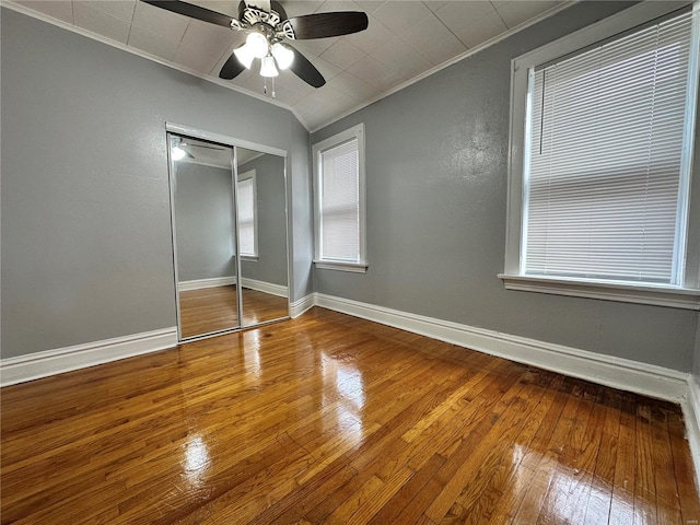 5056 Lindenwood Ave, Saint Louis, MO 63109 - unfurnished bedroom with ornamental molding, hardwood / wood-style flooring, a closet, baseboards, and ceiling fan
