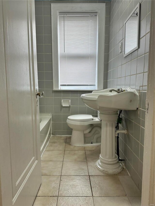 5056 Lindenwood Ave, Saint Louis, MO 63109 - full bathroom with tile walls, toilet, a tub, tile patterned floors, and a shower