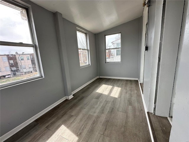 5056 Lindenwood Ave, Saint Louis, MO 63109 - unfurnished bedroom featuring lofted ceiling, wood finished floors, and baseboards