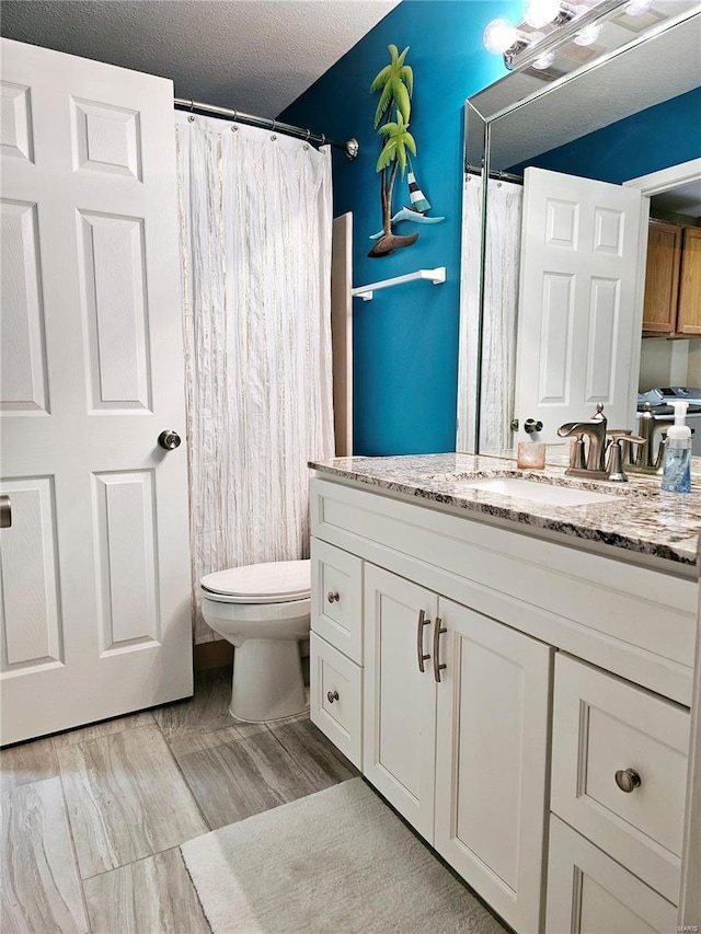 86 Aqua Fin Rd Unit 3B, Osage Beach, MO 65049 - full bath featuring toilet, vanity, wood finished floors, and a shower with shower curtain