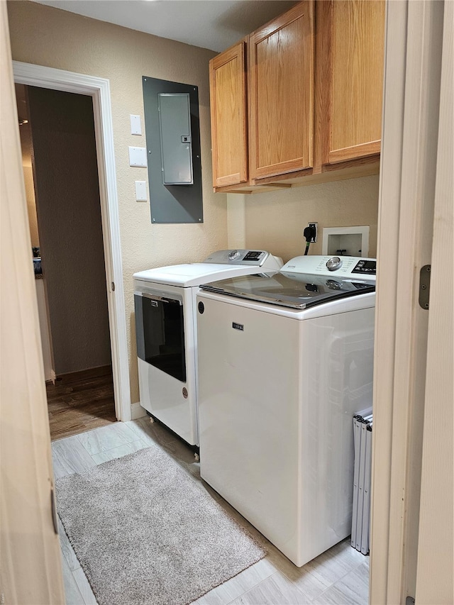 86 Aqua Fin Rd Unit 3B, Osage Beach, MO 65049 - laundry area with electric panel, separate washer and dryer, and cabinet space