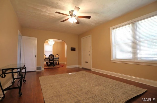 7710 Saint Albans Ave, Maplewood, MO 63117 - entryway featuring arched walkways, a ceiling fan, baseboards, and dark wood-type flooring