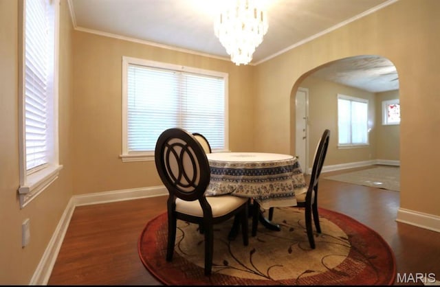7710 Saint Albans Ave, Maplewood, MO 63117 - dining space with arched walkways, wood finished floors, crown molding, baseboards, and a chandelier